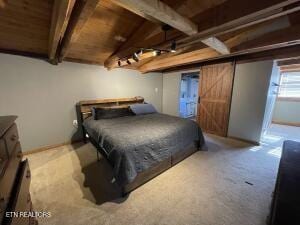 bedroom featuring a barn door, carpet floors, wood ceiling, and beam ceiling