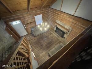 living room featuring wood-type flooring and beam ceiling