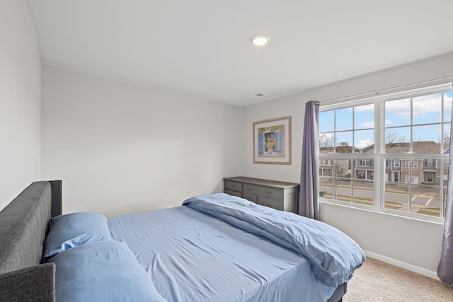 bedroom featuring light carpet