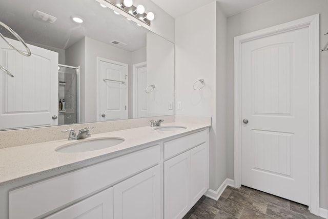 bathroom with an enclosed shower and vanity