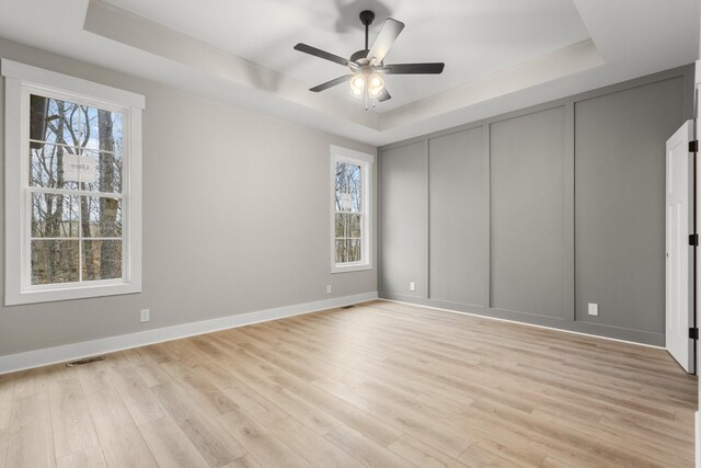 interior space with a wealth of natural light and a tray ceiling