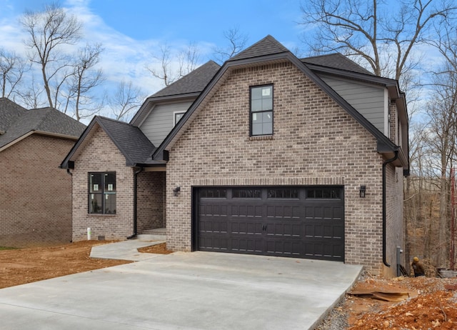 view of front facade with a garage, brick siding, driveway, and roof with shingles