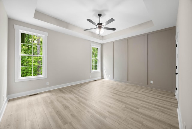 220 Birnam Wood Trce, Clarksville, TN 37043 - spare room featuring a raised ceiling, healthy amount of natural light, and light wood-style floors