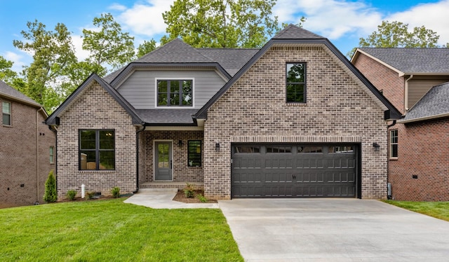 220 Birnam Wood Trce, Clarksville, TN 37043 - french country home with driveway, a front lawn, brick siding, an attached garage, and roof with shingles