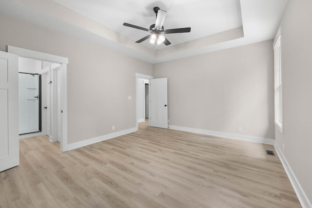 220 Birnam Wood Trce, Clarksville, TN 37043 - unfurnished bedroom featuring a raised ceiling, light wood-style floors, baseboards, and ceiling fan