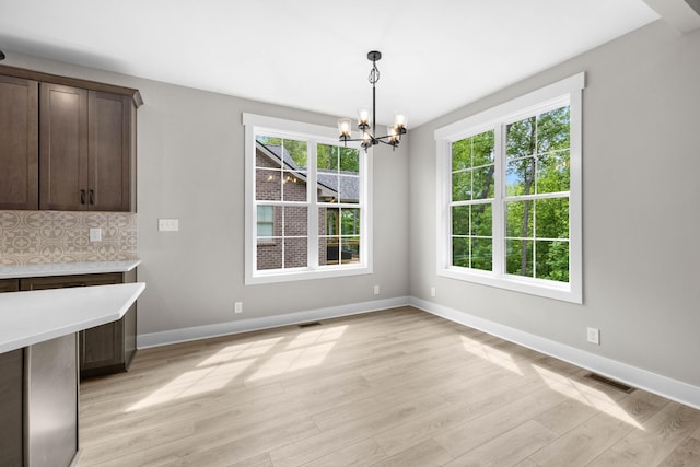 220 Birnam Wood Trce, Clarksville, TN 37043 - unfurnished dining area featuring a chandelier, plenty of natural light, light wood-style floors, and baseboards