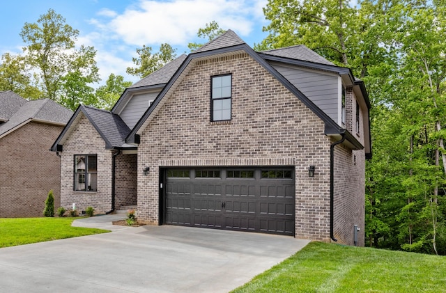220 Birnam Wood Trce, Clarksville, TN 37043 - french country style house with concrete driveway, a front yard, brick siding, and a garage