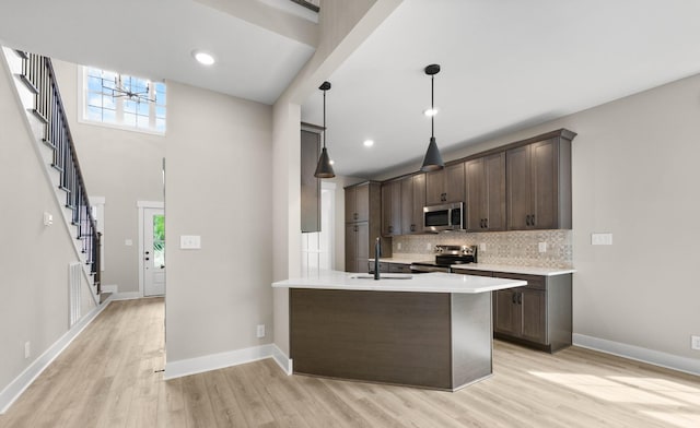 220 Birnam Wood Trce, Clarksville, TN 37043 - kitchen featuring appliances with stainless steel finishes, a sink, dark brown cabinetry, light wood finished floors, and recessed lighting