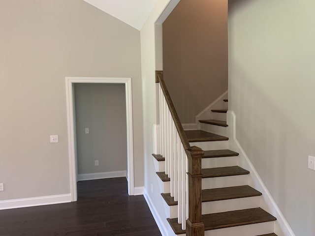 staircase with lofted ceiling and hardwood / wood-style flooring