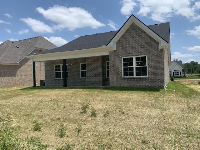 rear view of house with a lawn