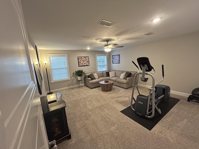 carpeted living room with ceiling fan