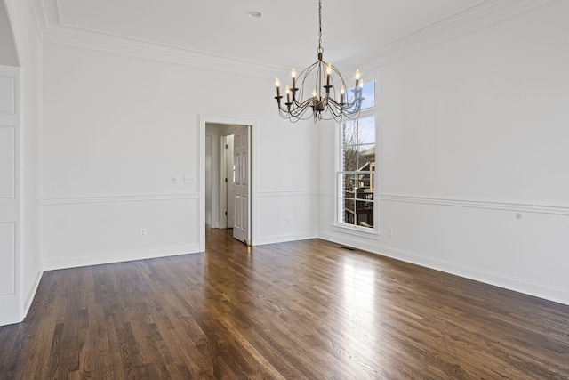 unfurnished dining area with an inviting chandelier, crown molding, and dark hardwood / wood-style floors