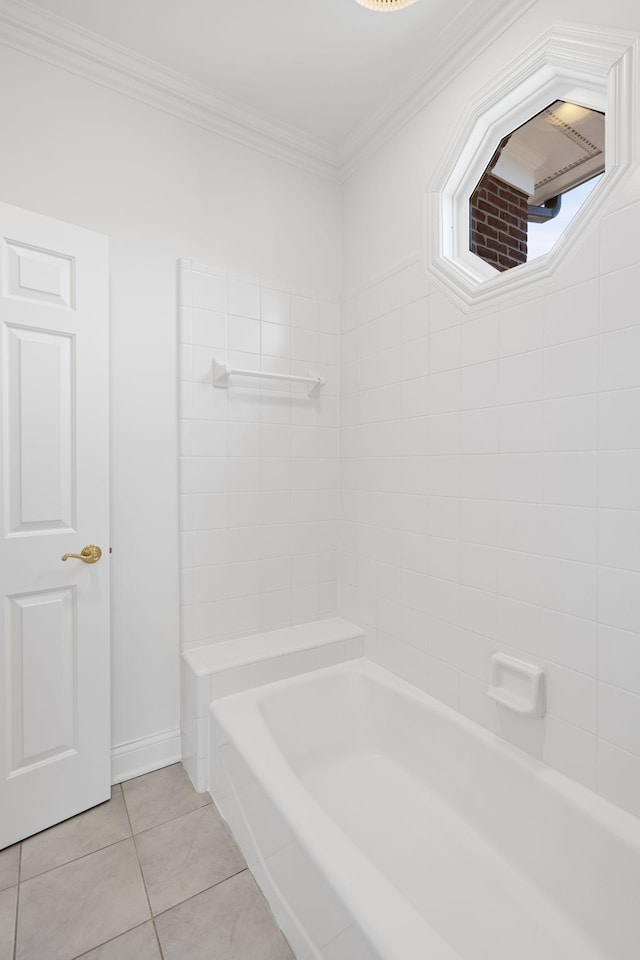 bathroom featuring tile patterned flooring, a bathing tub, and ornamental molding