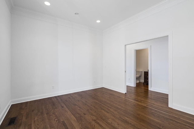 empty room with ornamental molding and dark hardwood / wood-style flooring