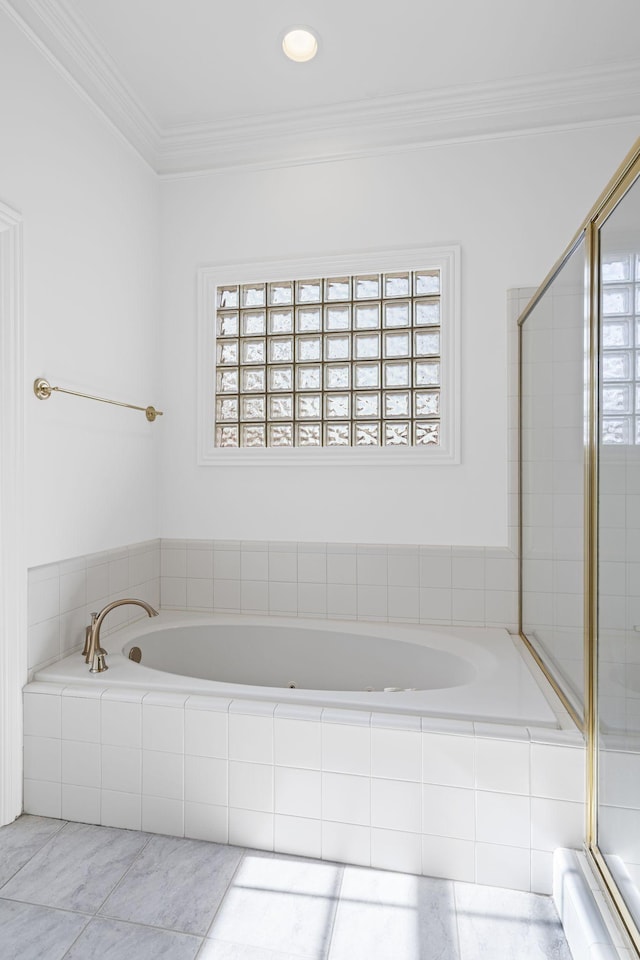 bathroom with ornamental molding and shower with separate bathtub