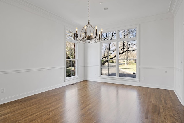 unfurnished dining area with ornamental molding, dark wood-type flooring, and a notable chandelier