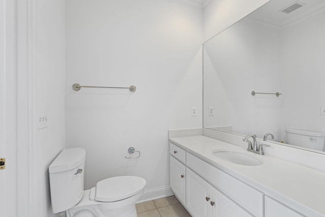 bathroom with crown molding, vanity, tile patterned floors, and toilet