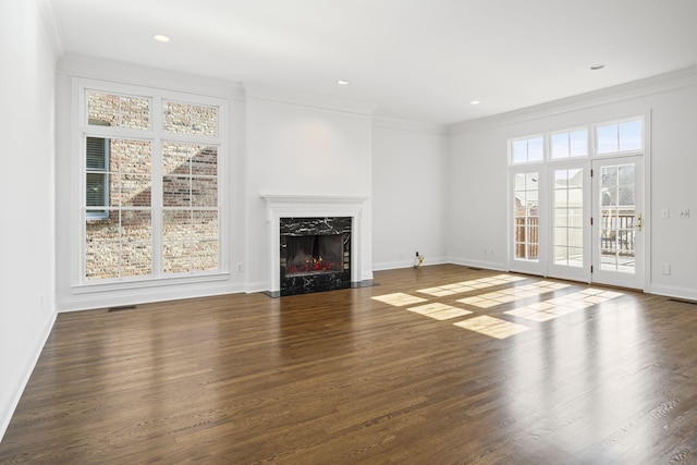 unfurnished living room with dark hardwood / wood-style flooring, a high end fireplace, and ornamental molding