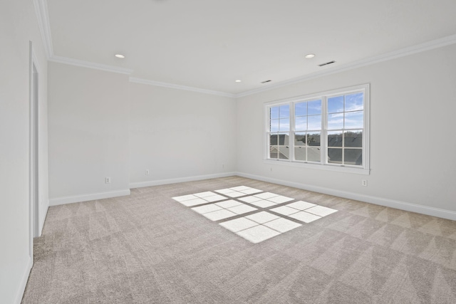 empty room featuring ornamental molding and light colored carpet