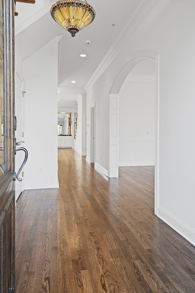 entryway with dark hardwood / wood-style flooring and crown molding