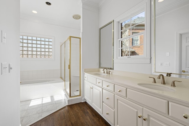 bathroom with crown molding, shower with separate bathtub, a healthy amount of sunlight, and vanity