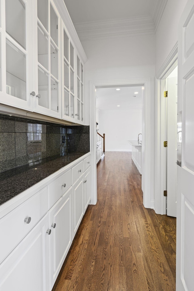 hall featuring dark hardwood / wood-style flooring and crown molding