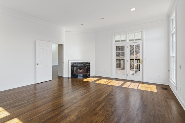 unfurnished living room featuring crown molding, dark hardwood / wood-style floors, and a premium fireplace