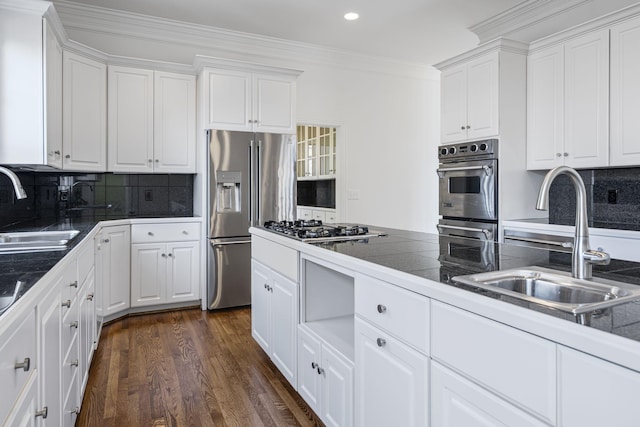 kitchen with sink, crown molding, white cabinets, and appliances with stainless steel finishes