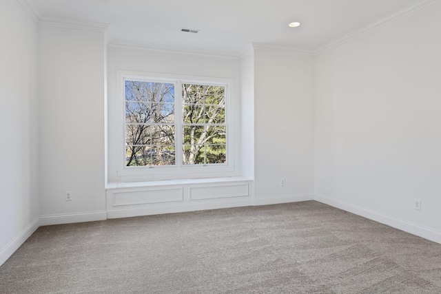 spare room featuring crown molding and carpet flooring