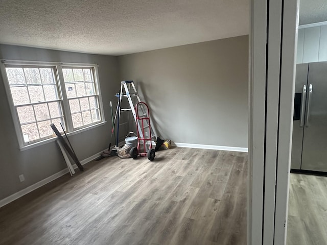 playroom featuring a textured ceiling and light wood-type flooring