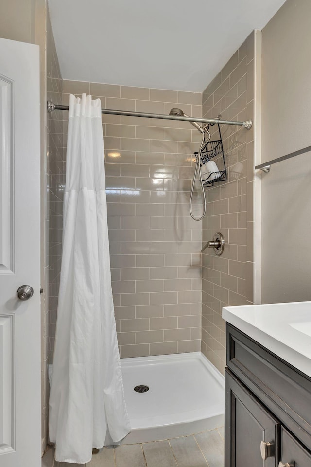 bathroom with vanity, tile patterned floors, and walk in shower