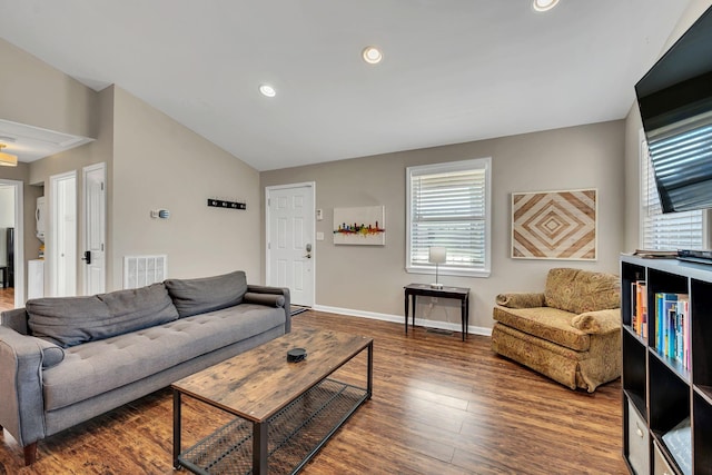 living room featuring lofted ceiling and dark wood-type flooring