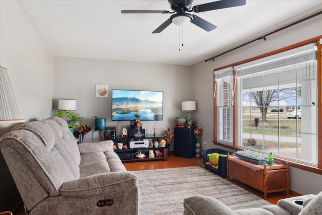 living room featuring hardwood / wood-style floors and ceiling fan