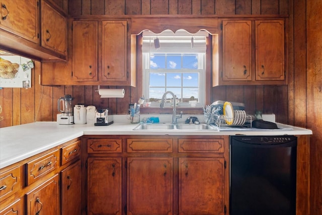 kitchen featuring dishwasher, sink, and wooden walls