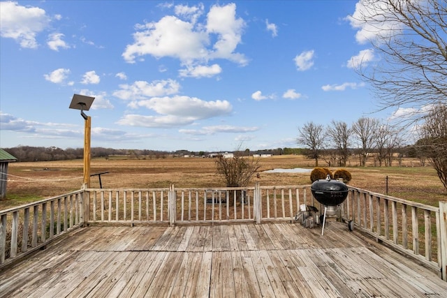 wooden deck featuring a grill and a rural view