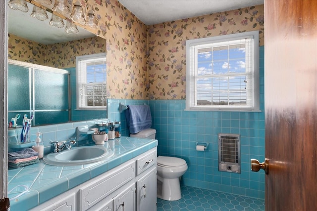 bathroom with walk in shower, tile patterned floors, toilet, heating unit, and vanity