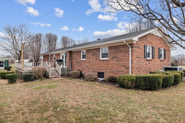 rear view of house featuring a wooden deck, a yard, and central air condition unit