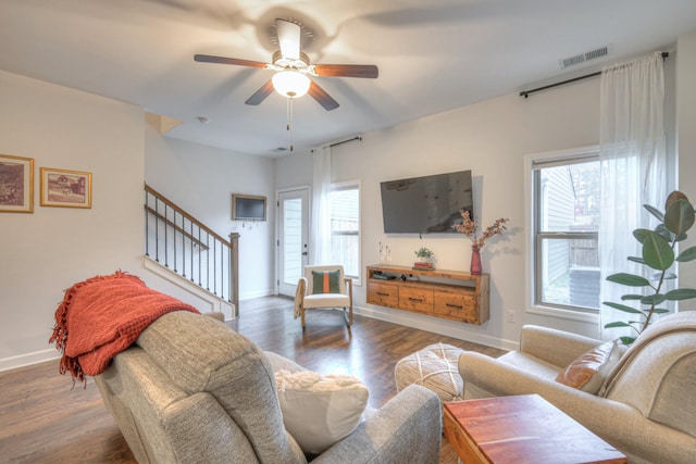 living room featuring ceiling fan, plenty of natural light, and dark hardwood / wood-style flooring