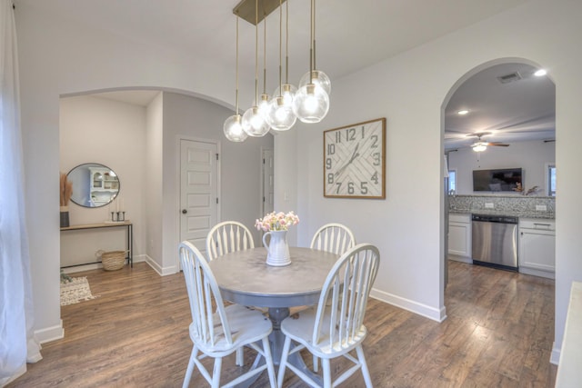 dining area featuring ceiling fan and dark hardwood / wood-style flooring