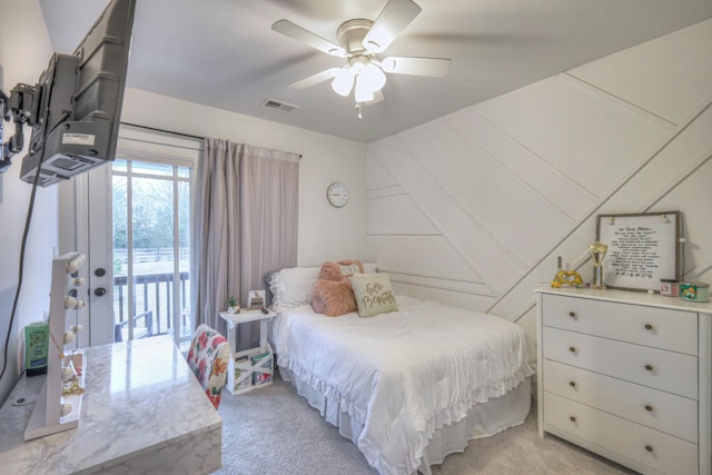 bedroom with ceiling fan, light colored carpet, visible vents, and access to exterior