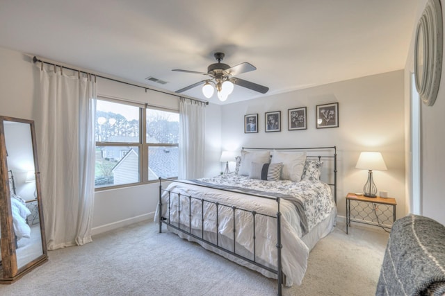 bedroom with baseboards, visible vents, ceiling fan, and carpet flooring