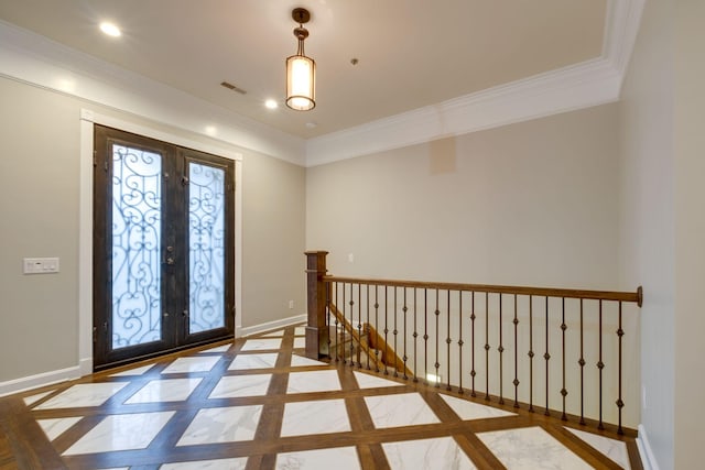 entryway with french doors, ornamental molding, and a wealth of natural light