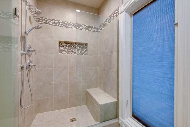 bathroom with a tile shower