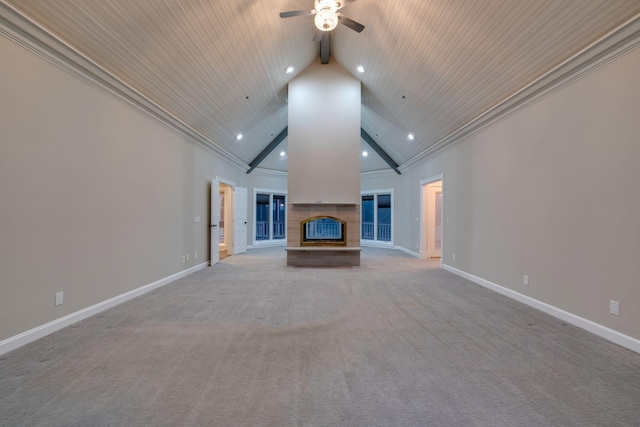 unfurnished living room featuring ceiling fan, high vaulted ceiling, a fireplace, light carpet, and beamed ceiling