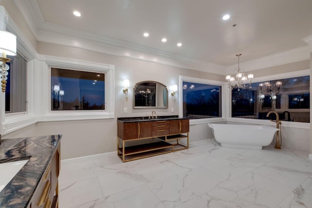 bathroom with vanity, a tub, ornamental molding, and a chandelier