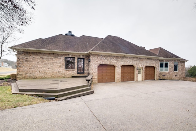 view of front of home featuring a wooden deck and a garage