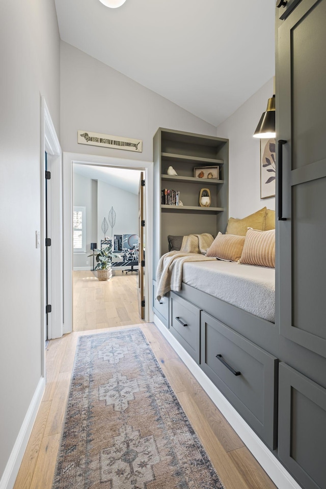 bedroom with lofted ceiling and light hardwood / wood-style flooring