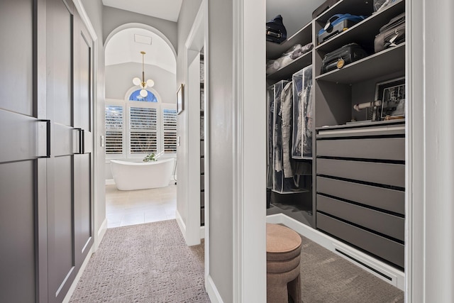 walk in closet with lofted ceiling and carpet