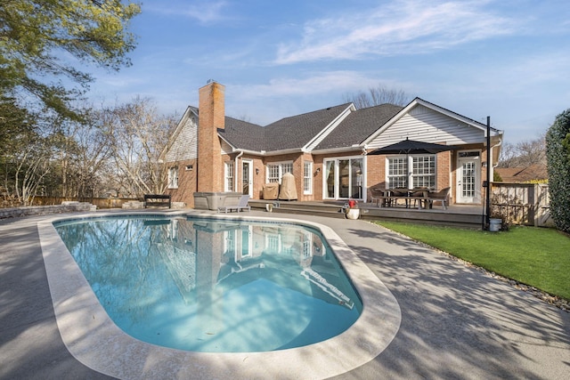 view of swimming pool with a hot tub, a patio, and a deck