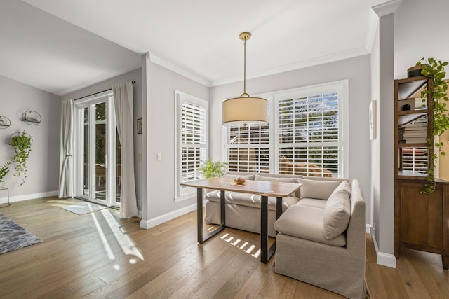 dining area featuring breakfast area, hardwood / wood-style floors, and ornamental molding